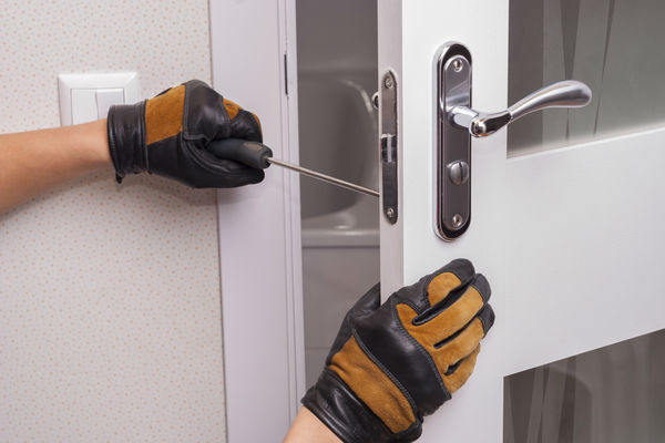 locksmith fitting a lock to an internal door